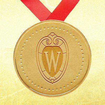 an image of a gold metal with the UW crest logo hanging from a red lanyard in front a yellow background